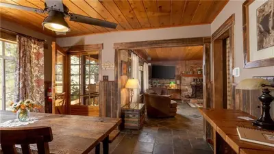 a living room with a wooden ceiling and a table at Hot Tub, Near Village/Lake - Kelly`s Kottage in Big Bear Lake