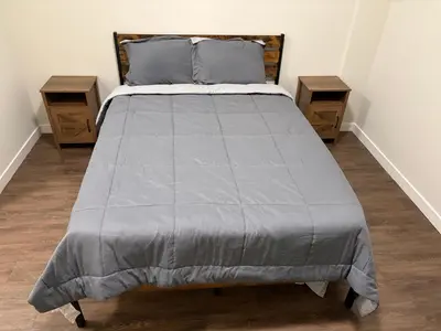 a bed in a room with two night stands at Poolside Palace in Los Angeles