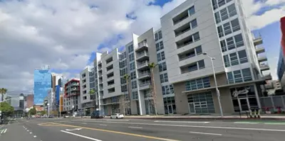 an empty street in a city with tall buildings at Poolside Palace in Los Angeles