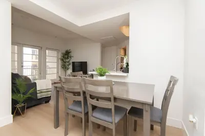 a kitchen and dining room with a table and chairs at By The Coast Living in Santa Monica Pier Promenade in Los Angeles