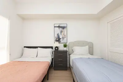 two beds sitting next to each other in a bedroom at By The Coast Living in Santa Monica Pier Promenade in Los Angeles