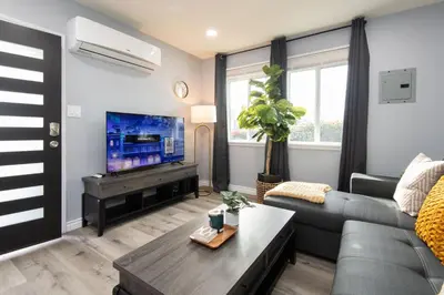 a living room with a couch and a tv at 3bedroom 2bath Unit complementary parking onsite in Los Angeles