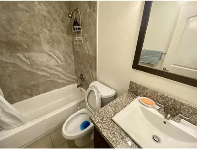 a bathroom with a sink and a toilet and a bath tub at Females room bunk beds in Los Angeles