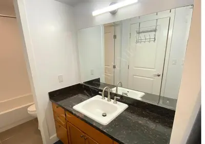 a bathroom with a sink and a mirror at Luxury condo in the heart of LA in Los Angeles