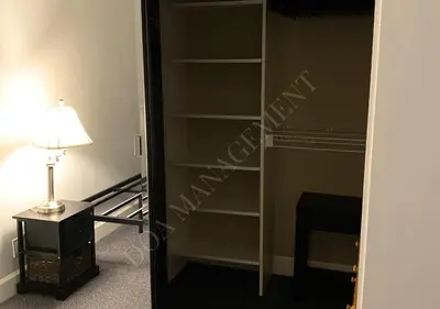 a room with a book shelf next to a lamp at Luxury condo in the heart of LA in Los Angeles