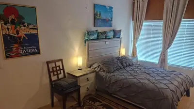 a bedroom with a bed and a dresser and a chair at Golden House in Santa Clarita