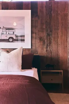 a bedroom with a bed and a black cat on a table at Malibu ranch retreat in Malibu