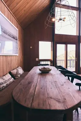 a dining room with a wooden table and chairs at Malibu ranch retreat in Malibu