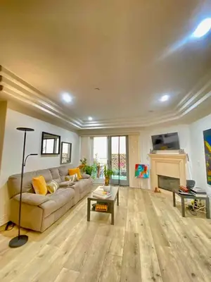a living room with a couch and a fireplace at Studio City Chic Large Contemporary Condo in Los Angeles