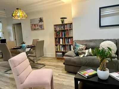 a living room with a couch and a table at Studio City Chic Large Contemporary Condo in Los Angeles