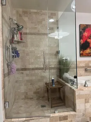 a shower with a glass door next to a tub at Studio City Chic Large Contemporary Condo in Los Angeles