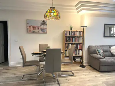 a living room with a table and a couch at Studio City Chic Large Contemporary Condo in Los Angeles