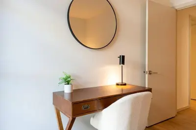 a dressing table with a mirror on a wall at Emerald Ridge - Luxe Hollywood Walk of Fame in Los Angeles