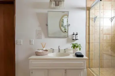 a bathroom sink with a mirror and a shower at Malibu Villa with Beach Access and Ocean View in Malibu