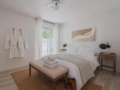 a white bedroom with a bed and a window at Malibu Villa with Beach Access and Ocean View in Malibu
