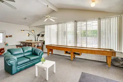 a living room with a ping pong table and a couch at 12 Mi to Dtwn LA Family Home with Patio and Yard! in Downey