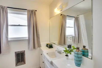 a bathroom with a sink and a mirror at 12 Mi to Dtwn LA Family Home with Patio and Yard! in Downey