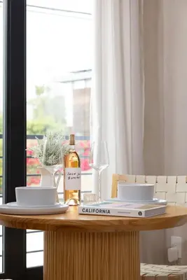 a table with a bottle of wine and a glass at Luxe 2BR with Designer Touches, Walk to Everything in Los Angeles