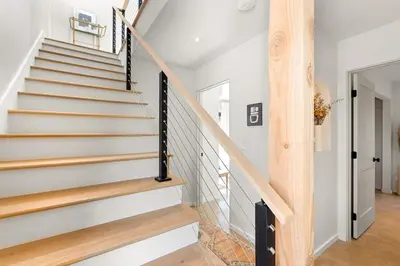 a staircase in a house with white walls and wooden floors at Luxe 2BR with Designer Touches, Walk to Everything in Los Angeles