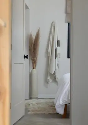 a bedroom with a door with a vase next to a bed at Luxe 2BR with Designer Touches, Walk to Everything in Los Angeles