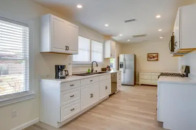 a kitchen with white cabinets and a refrigerator at Walk to Dtwn Tehachapi Updated Getaway with Yard! in Tehachapi