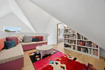 a living room with a couch and a book shelf at New Listing Hillside Villa by Colby & Conrad in Los Angeles