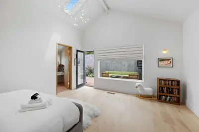 a bedroom with a bed and a window with a couch at New Listing Hillside Villa by Colby & Conrad in Los Angeles