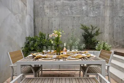 a table with glasses and food on top of it at New Listing Hillside Villa by Colby & Conrad in Los Angeles