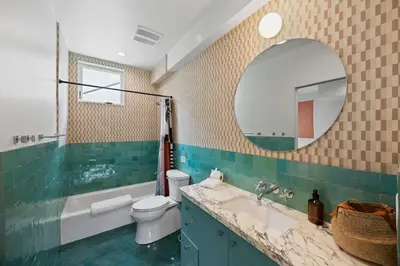 a bathroom with a sink and a toilet and a mirror at New Listing Hillside Villa by Colby & Conrad in Los Angeles