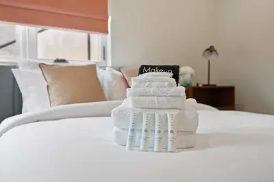 a stack of towels stacked on a bed at New Listing Hillside Villa by Colby & Conrad in Los Angeles