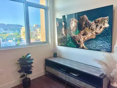 a living room with a fish tank and two windows at Penthouse with Hollywood Sign View 2 Bedrooms with 3 Beds in Los Angeles