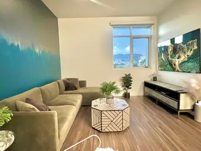 a living room with a couch and a piano at Penthouse with Hollywood Sign View 2 Bedrooms with 3 Beds in Los Angeles