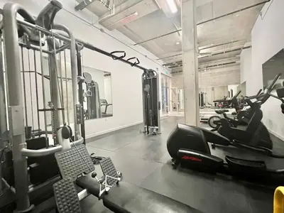 a gym with treadmills and exercise bikes in it at Penthouse with Hollywood Sign View 2 Bedrooms with 3 Beds in Los Angeles