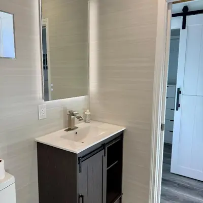 a bathroom with a sink and a mirror at Guesthouse in Hewitt