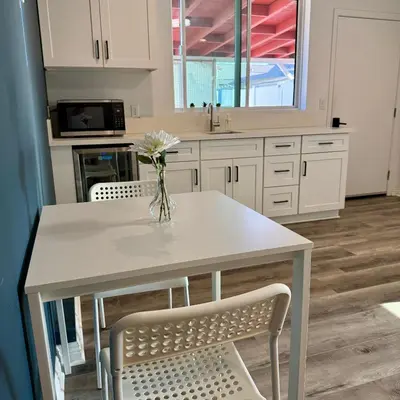 a kitchen with a table with a vase of flowers on it at Guesthouse in Hewitt