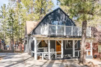 a small house with a porch and a balcony at The Wilderness Haven in Big Bear Lake