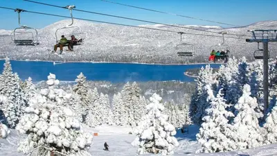 a group of people riding a ski lift in the snow at The Wilderness Haven in Big Bear Lake