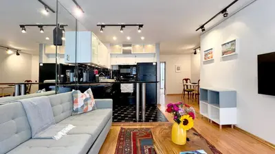 a living room with a couch and a kitchen at Charming 1BR in Prime Santa Monica Walk to Beach in Los Angeles