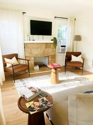 a living room with a couch and a fireplace at Cozy Hollywood Cottage - Free Parking in Los Angeles