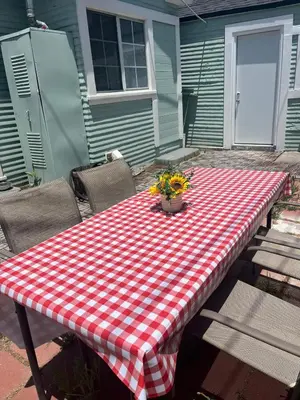 a picnic table with a red and white checkered table cloth at Cozy Hollywood Cottage - Free Parking in Los Angeles