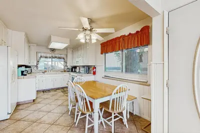 a kitchen with a table and chairs and a ceiling fan at Bright Moon in Lake Arrowhead