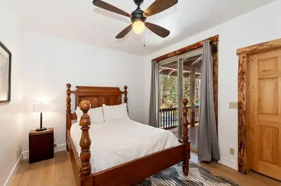 a bedroom with a bed and a ceiling fan at California Dreaming: Lakeside Cabin Getaway in the Best Location in San Bernardino