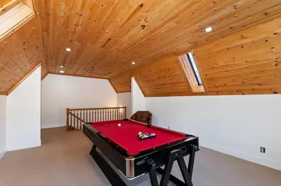 a pool table in a room with a wooden ceiling at California Dreaming: Lakeside Cabin Getaway in the Best Location in San Bernardino