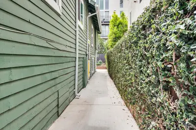 a green house with a sidewalk next to a building at 1 Mi to Dtwn LA Artists Retreat with Zen Garden in Los Angeles