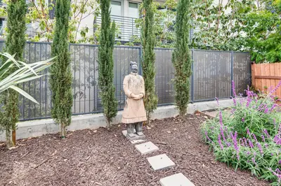 a statue of a woman standing in a garden at 1 Mi to Dtwn LA Artists Retreat with Zen Garden in Los Angeles