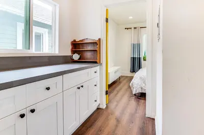 a kitchen with white cabinets and a window at 1 Mi to Dtwn LA Artists Retreat with Zen Garden in Los Angeles