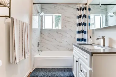 a white bathroom with a tub and a sink at 1 Mi to Dtwn LA Artists Retreat with Zen Garden in Los Angeles