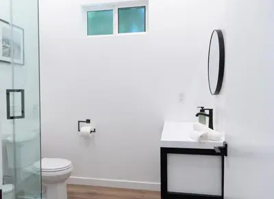 a bathroom with a toilet and a sink and a mirror at New 2BR Family Home Nr Universal in Gemco