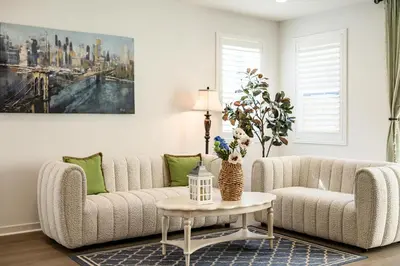 a living room with a couch and a table at Spacious 5BR Getaway w Game Room & Modern Comfort in Fontana