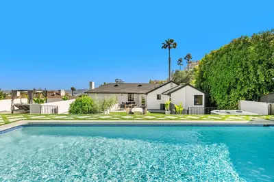 a large swimming pool in front of a house at Villa Incanto in Los Angeles